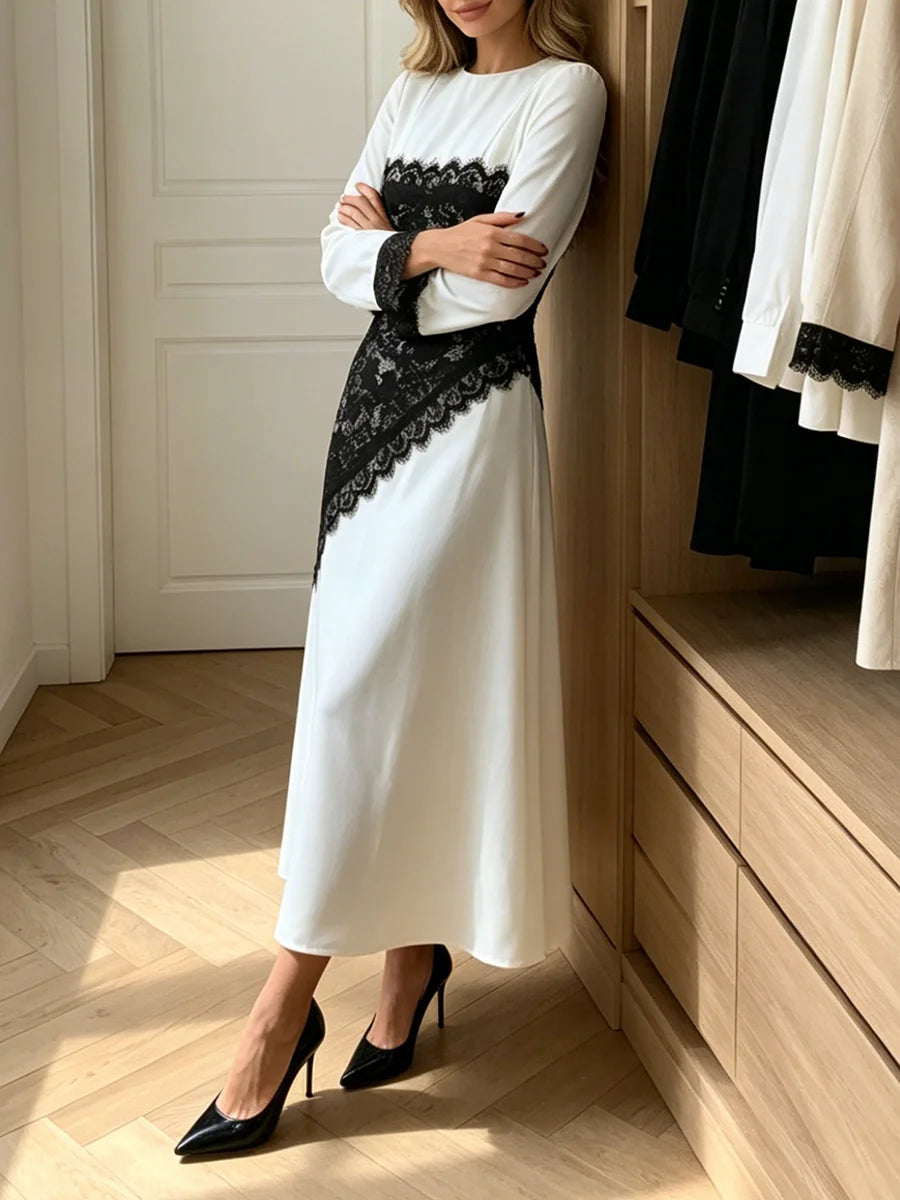 Model posing in a black lace panel long sleeve midi dress.