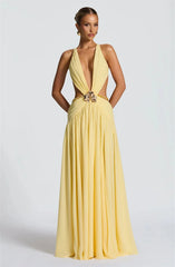 Yellow evening gown with a deep neckline and embellishments on a white background