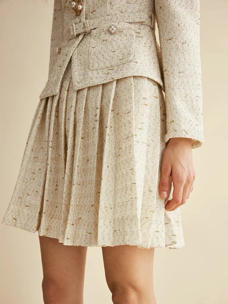 Beige textured skirt with a matching jacket on a beige background