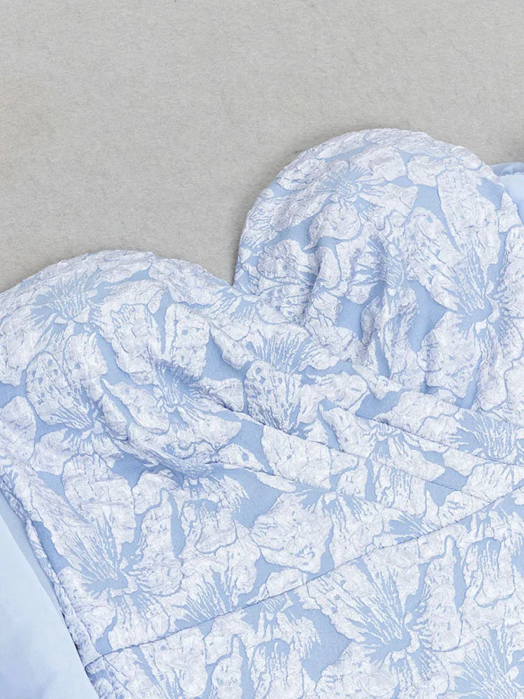 Heart-shaped blue and white patterned fabric on a gray background