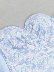 Heart-shaped blue and white patterned fabric on a gray background