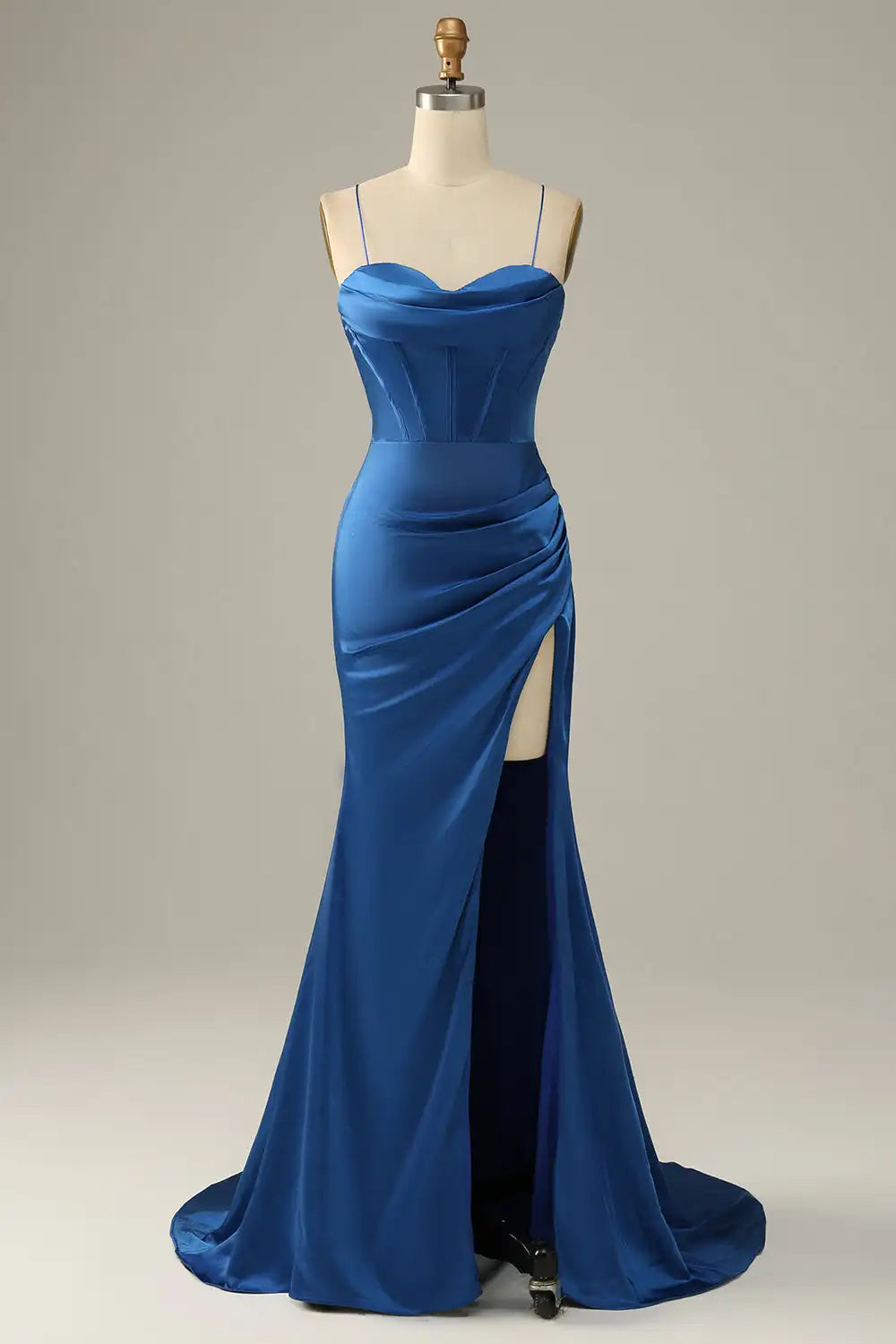 Blue evening gown on a mannequin against a plain background