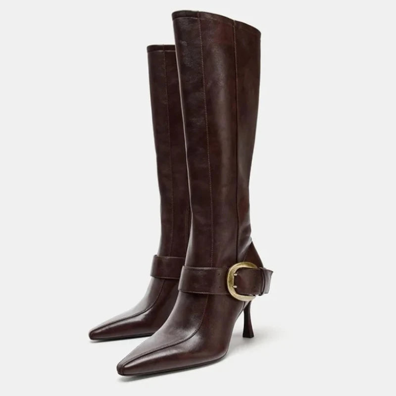 Pointed toe stiletto heel knee high boots with buckle detail.