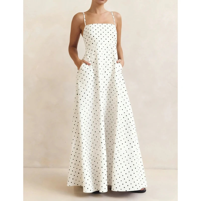 White dress with black polka dots on a neutral background
