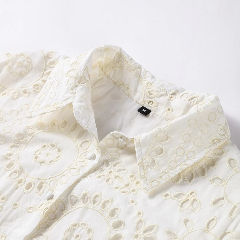 White lace garment with a brand label on a light gray background