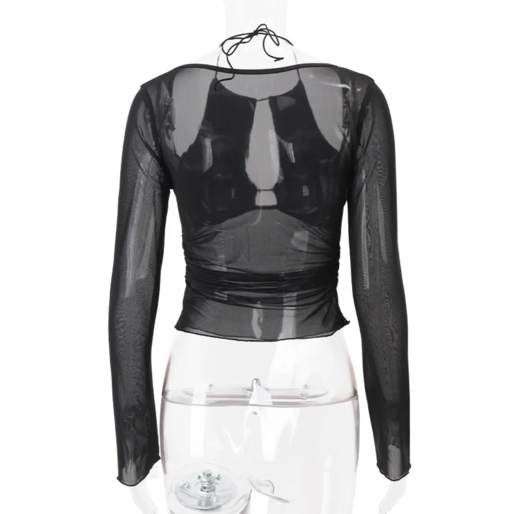 Black sheer long-sleeve top on a mannequin against a white background