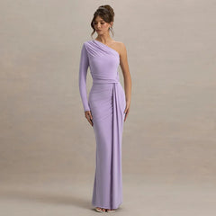 Woman wearing a one-shoulder lavender gown against a beige background