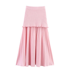 Pink skirt with textured top and pleated skirt on a white background