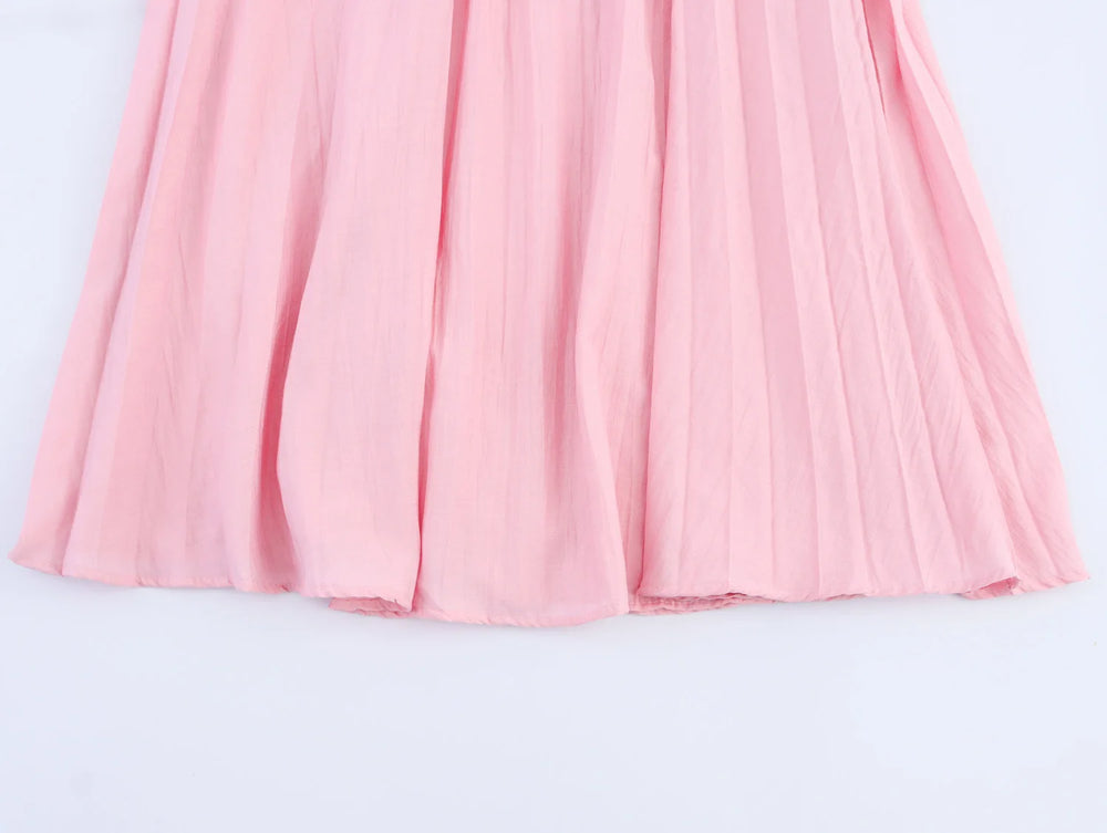 Pink pleated skirt on a light gray background