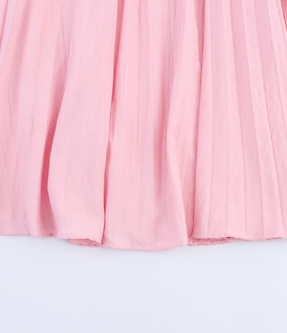 Pink pleated skirt on a light gray background
