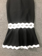 Black skirt with white lace trim on a gray background