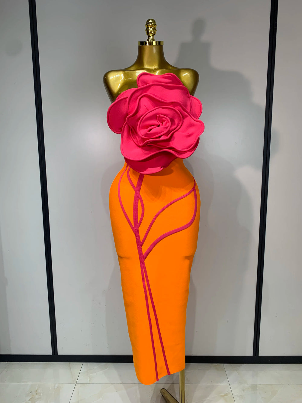 Orange strapless sheath dress with hot pink floral applique and pink trim