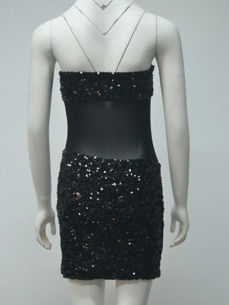 Black sequin dress on a mannequin against a gray background