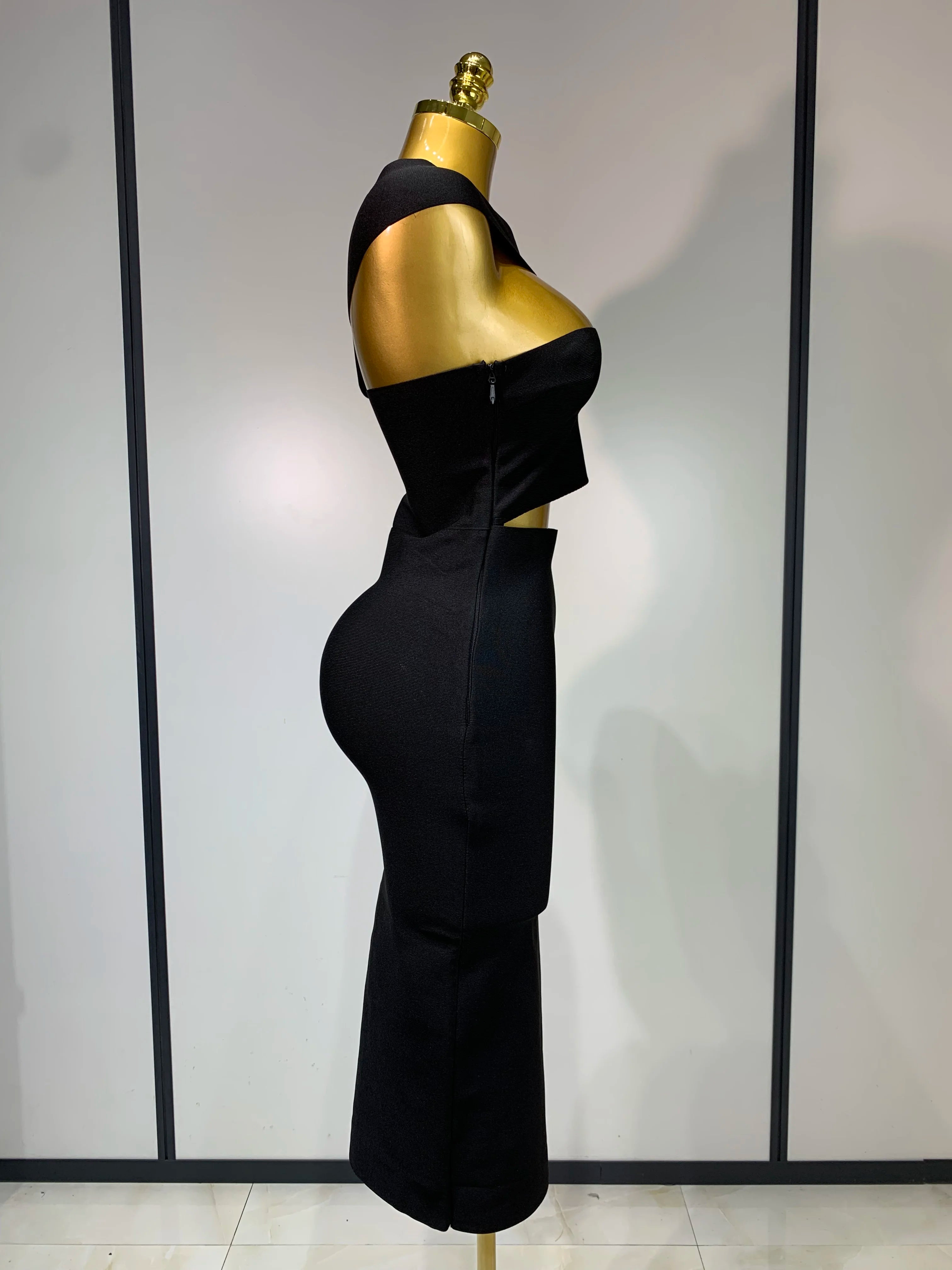 Black strapless sheath midi dress with hollow out detail.