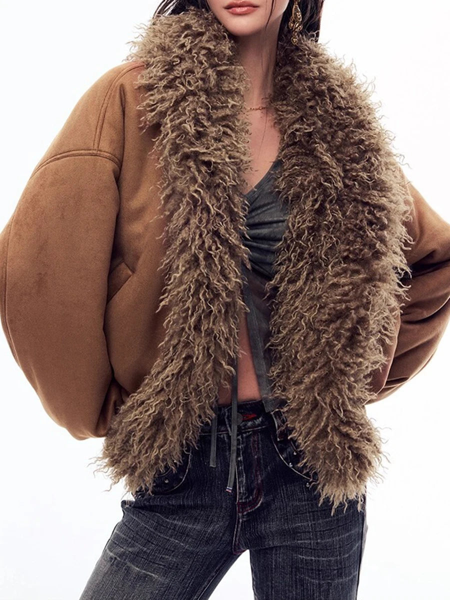 Person wearing a brown fur vest over a brown jacket