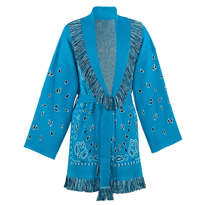 Blue cardigan with fringe details on a white background