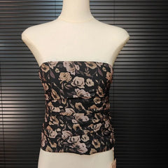Floral strapless top on a mannequin against a dark background