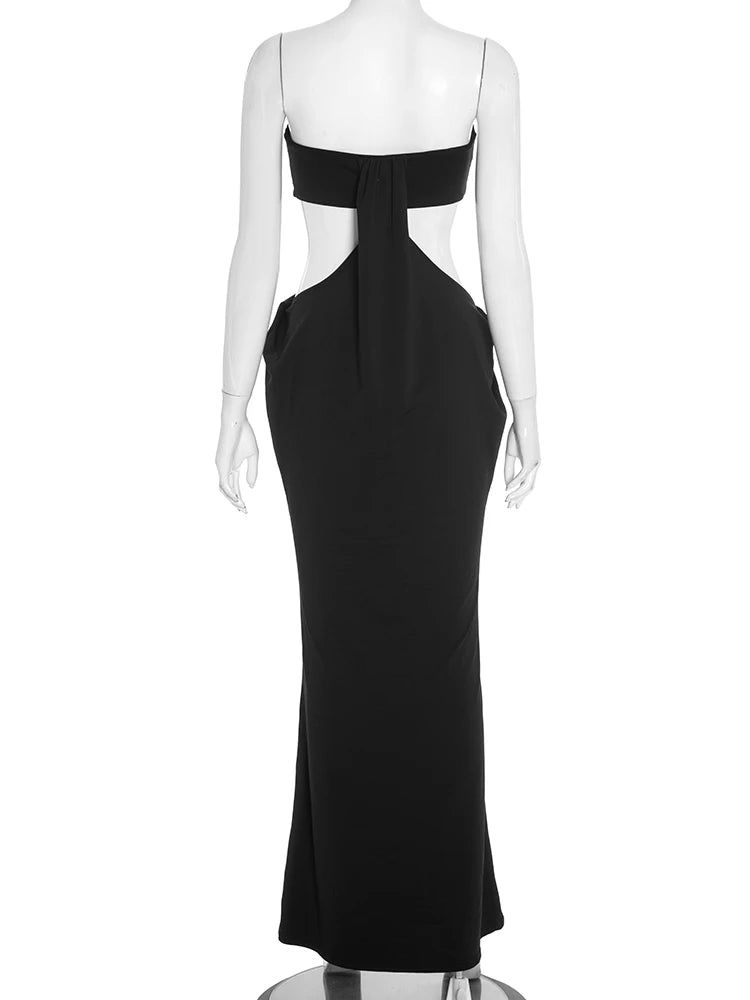 Black evening gown on a mannequin against a white background