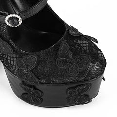 Black lace platform shoe with butterfly details on a white background
