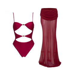 Flat lay of cutout detail embellished one-piece and sheer skirt swimwear set