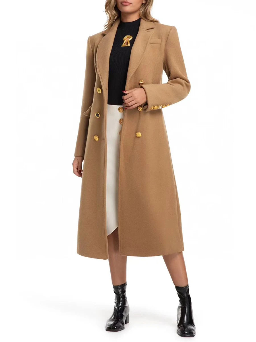 Woman wearing a long beige coat with gold buttons