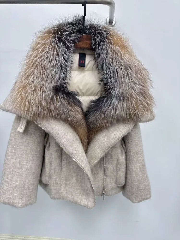 Beige coat with fur collar on a hanger against a white background