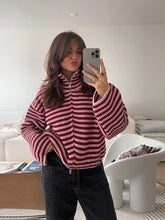 Striped knit sweater with stand collar and zip closure