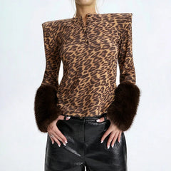 Leopard print long sleeve top with brown fur trim cuffs and structured shoulders