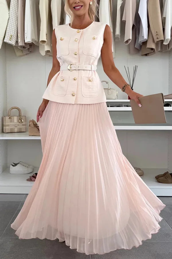 Woman wearing a light pink dress with a white jacket in a store setting.