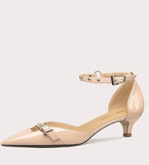 Beige high-heeled shoe on a light gray background
