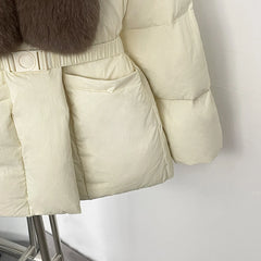 Beige puffer jacket with fur trim on a mannequin against a white background