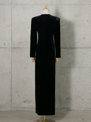 Black dress on a mannequin against a concrete wall