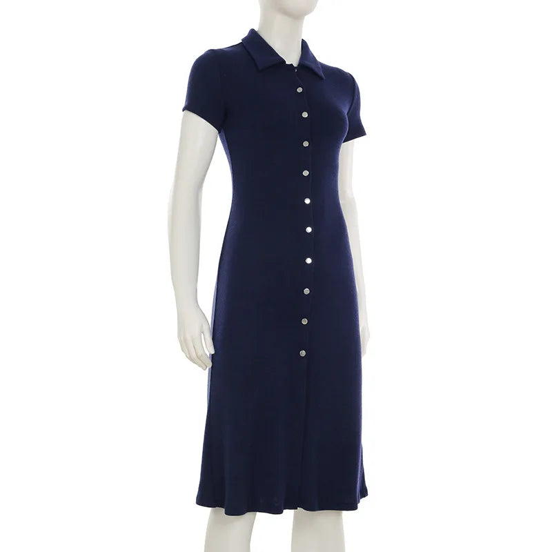 Navy blue dress on a mannequin against a white background