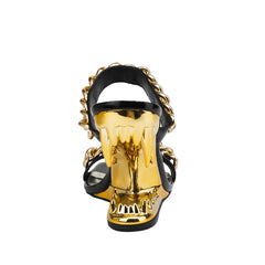 Gold skull-shaped high-heeled sandal on a white background