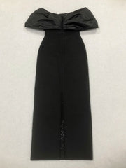 Black off-shoulder dress with a textured background