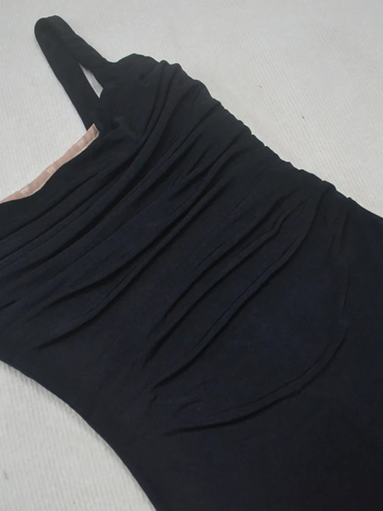 Black dress with a unique cutout design on a light gray background