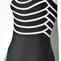 Black dress with white stripes on a plain background