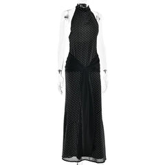 Black dress with white polka dot pattern on a mannequin against a white background
