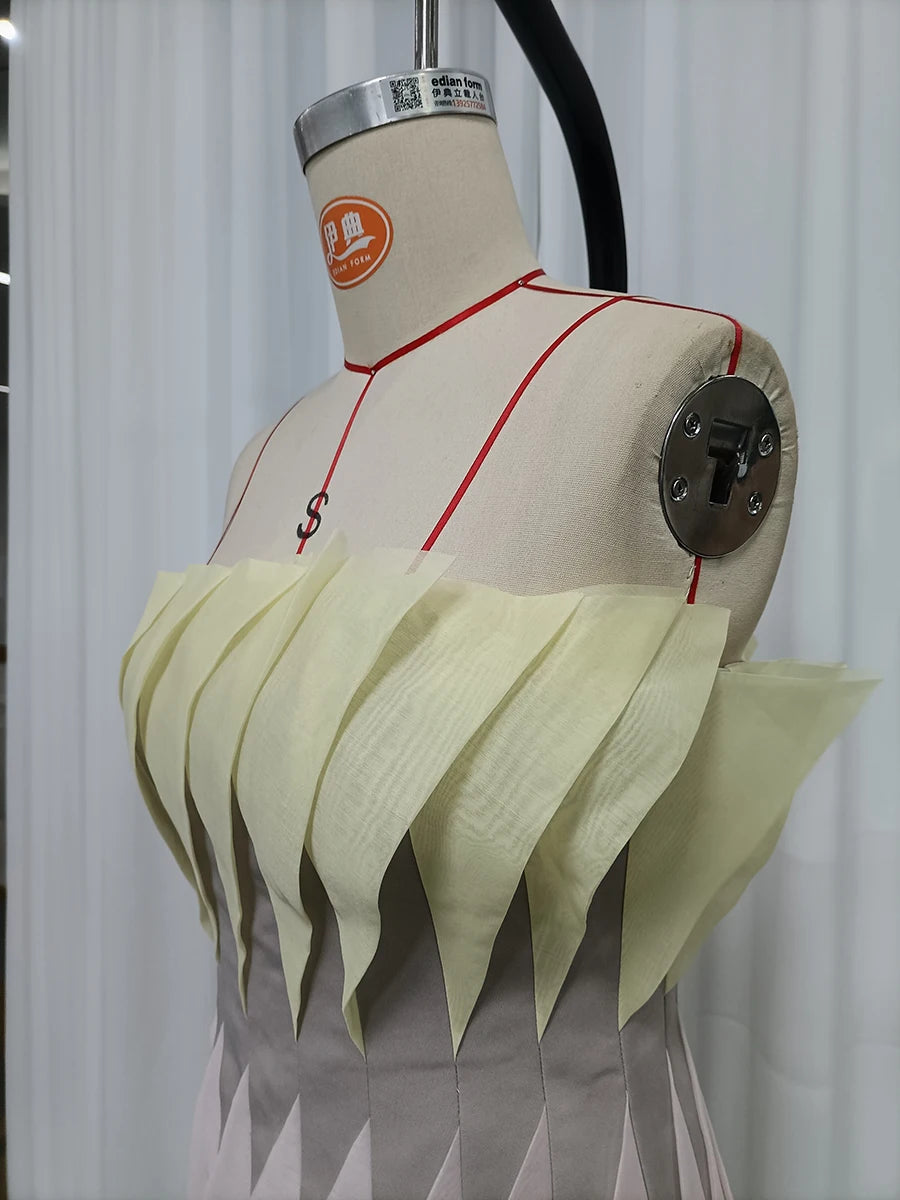 Close-up of pleated peplum detail on mannequin