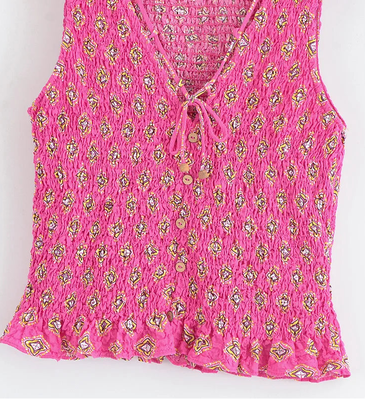 Pink floral patterned top on a white background