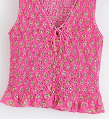 Pink floral patterned top on a white background