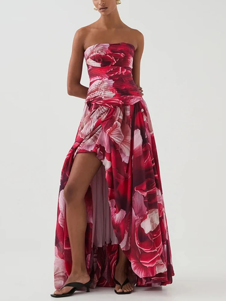 Woman wearing a strapless  pink red floral dress on a white background