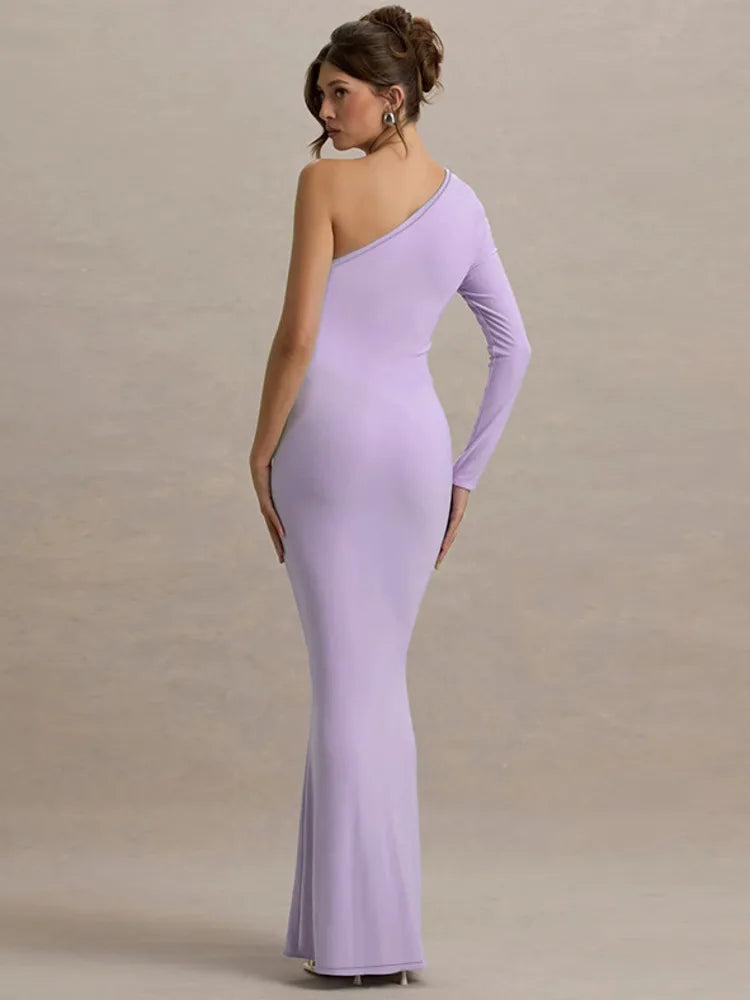 Woman wearing a one-shoulder lavender dress against a plain background