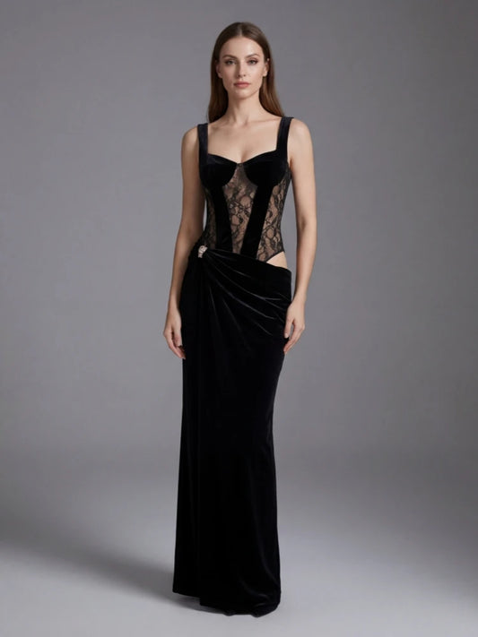 Woman wearing a black evening gown with lace detailing on a gray background