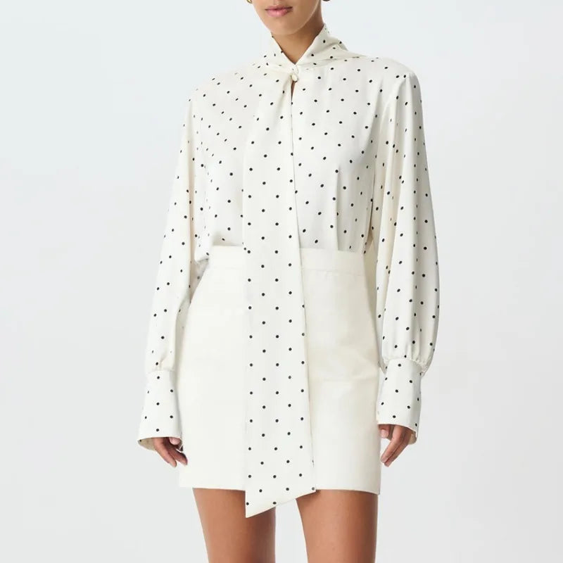 White shirt dress with black polka dots on a white background