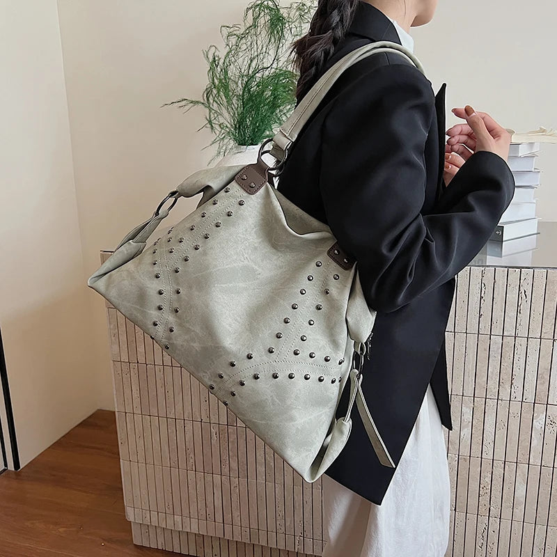 Green studded PU leather shoulder bag on a person