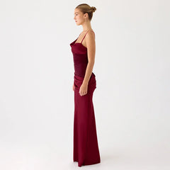 Woman wearing a burgundy evening gown on a white background