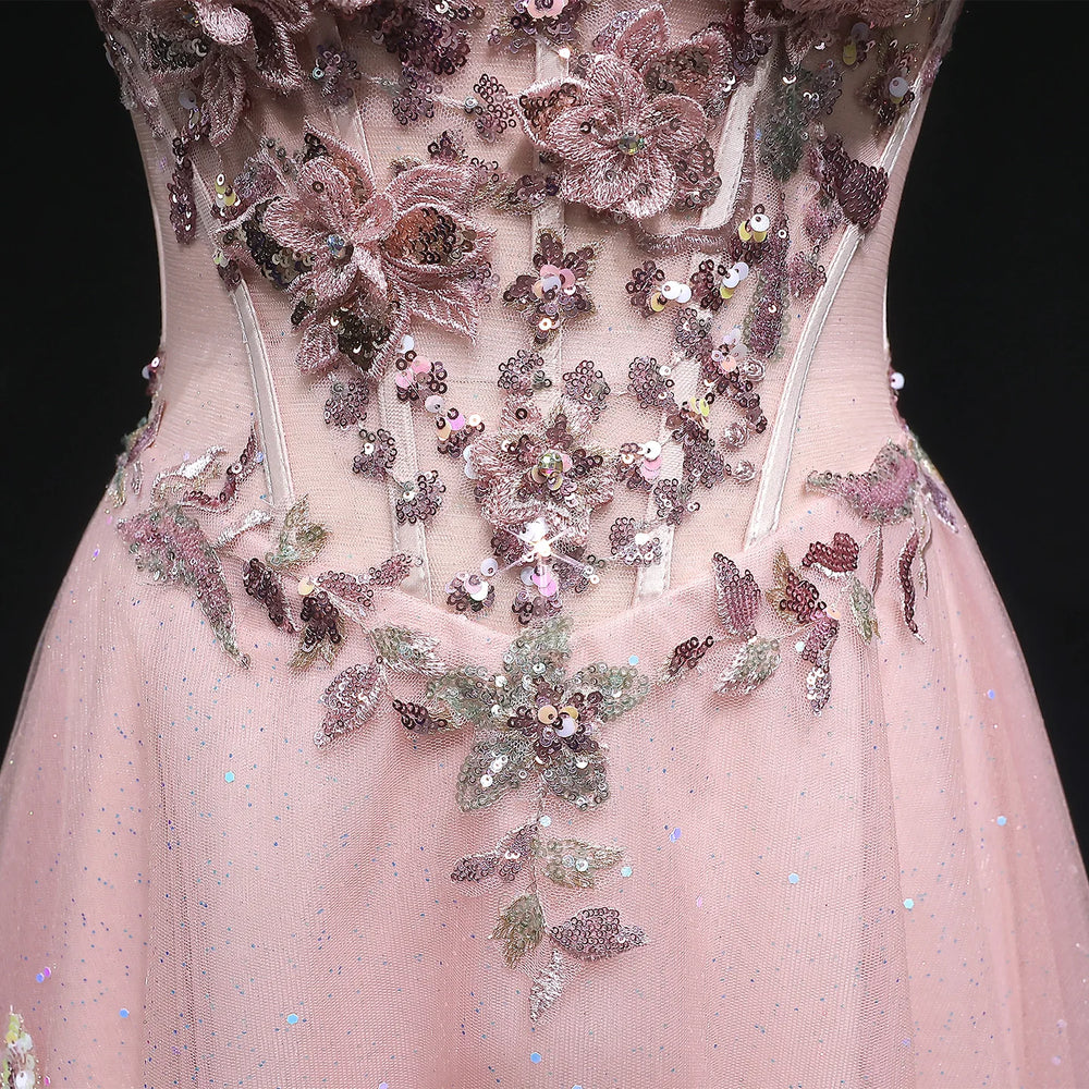 Pink dress with floral embellishments and sequins on a black background