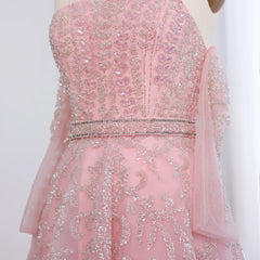 Pink beaded dress on a mannequin against a white background