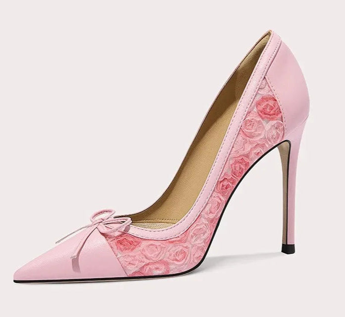 Pink high-heeled shoe with floral design on a white background